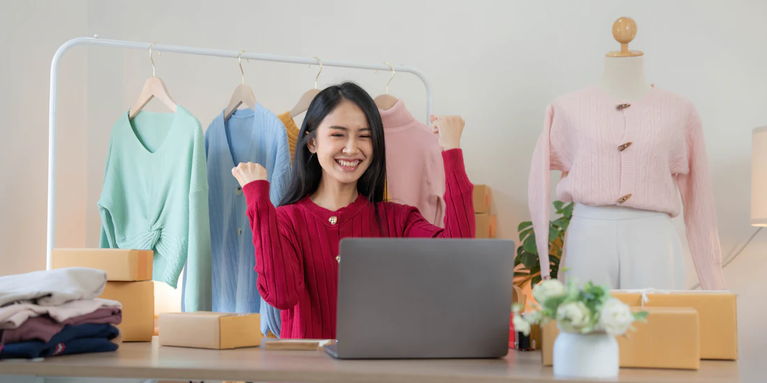 Fashion e-commerce owner managing her store on a laptop