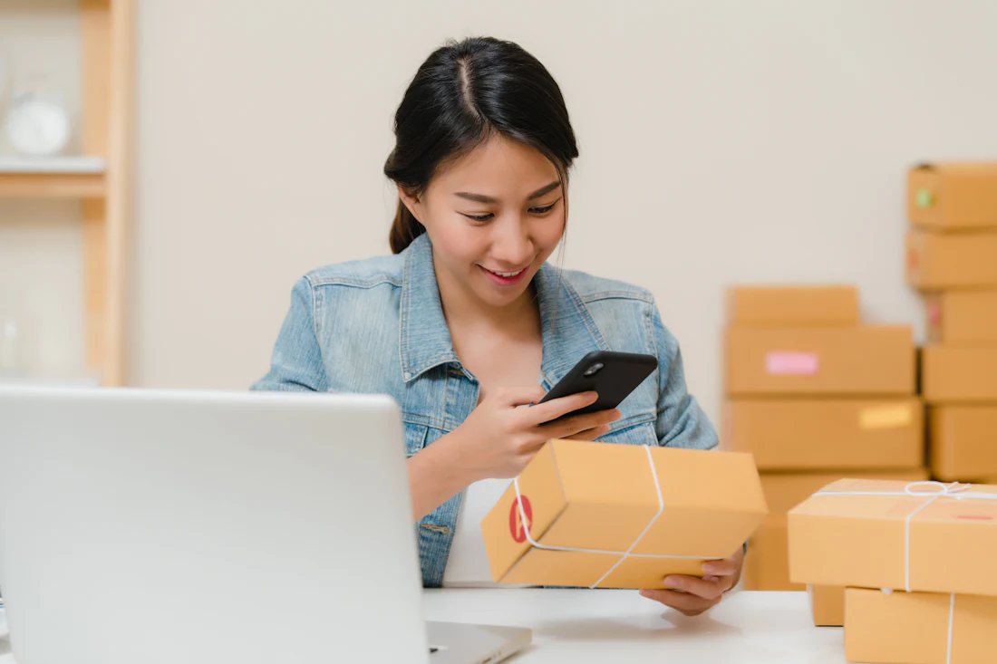 Online store owner checking orders on her phone